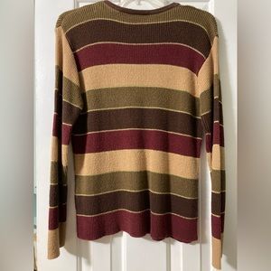 This sweater has golden shimmers all over it in between the stripes